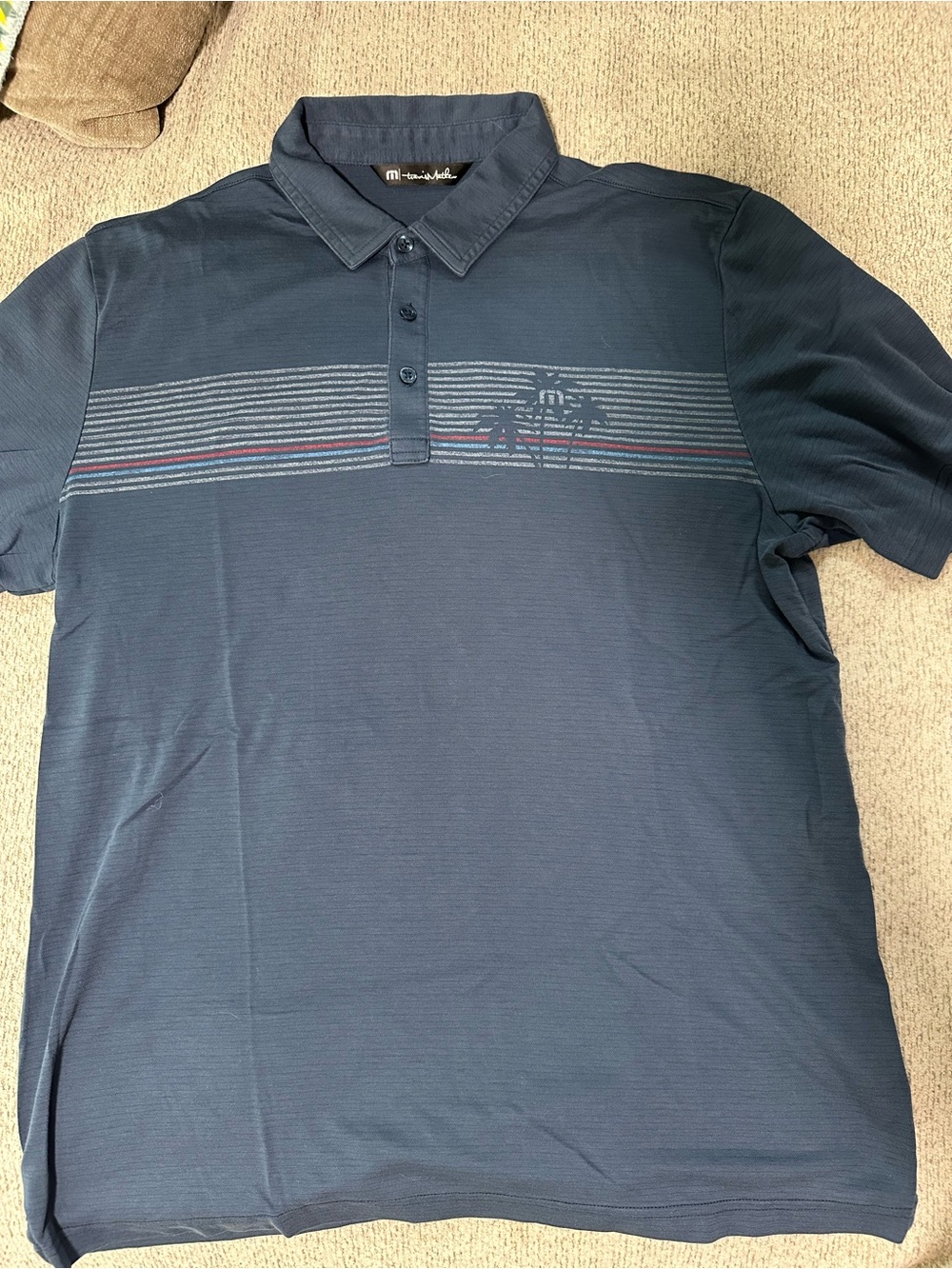 TravisMathew Men's Navy Polo with Subtle Stripe Detail and Palm tree decal